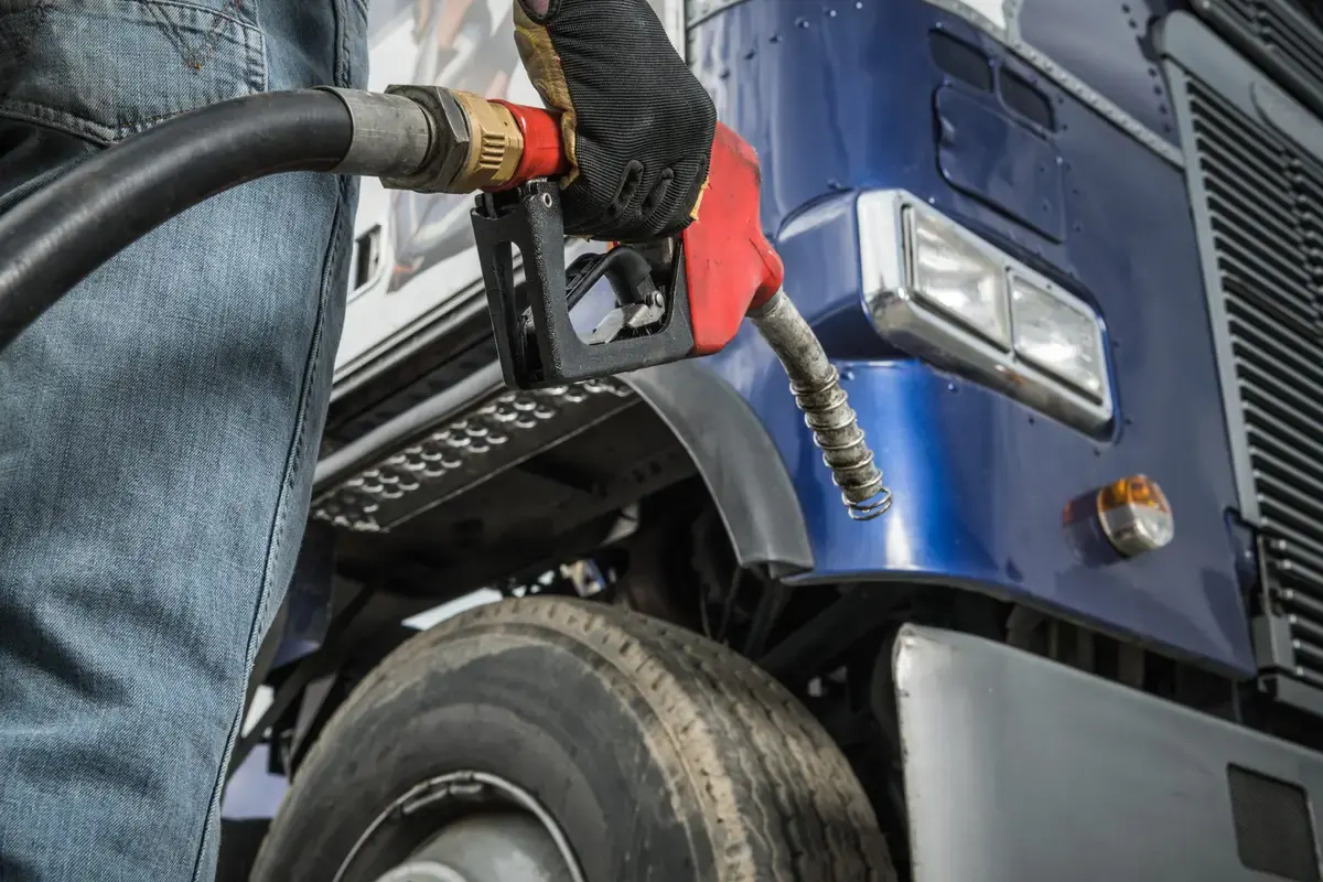 Owner-operator standing in front of his truck