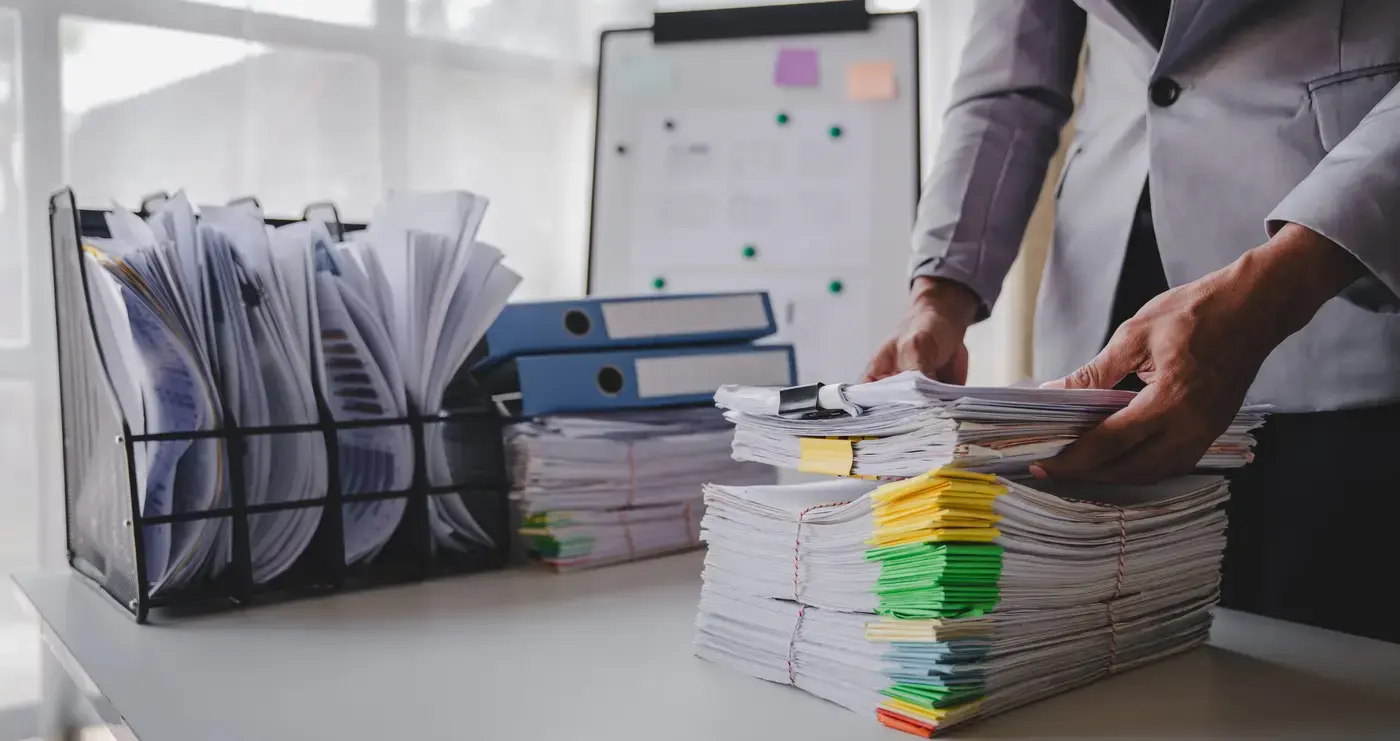 Carrier paperwork and a laptop on an office desk